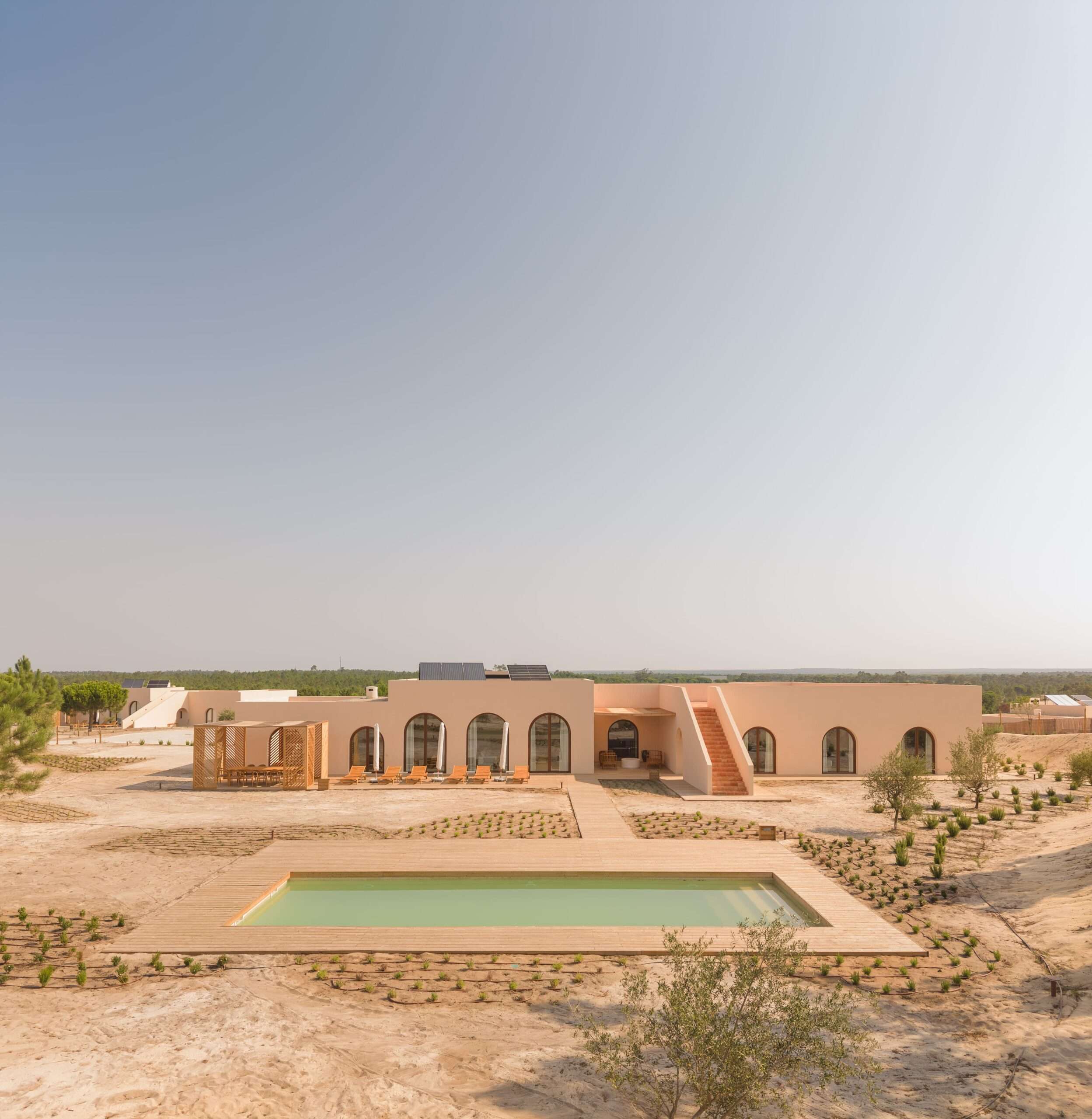 Villa facade with arched openings, rooftop staircase, and pool, Comporta